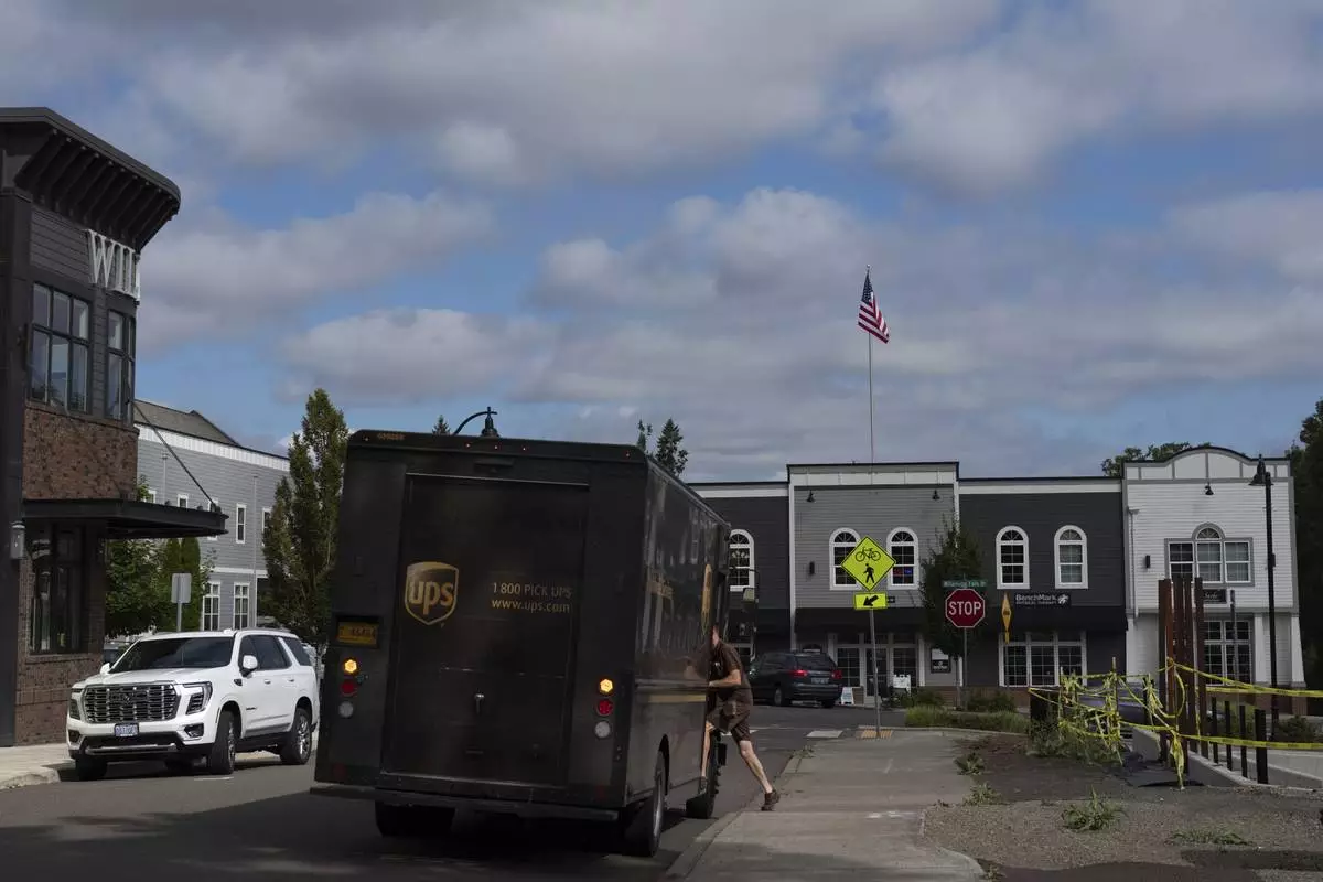 CORRECTS COMPANY NAME: A UPS driver gets into their vehicle after delivering packages at A Sight For Sport Eyes, a brick-and-mortar and e-commerce store for sport goggles, Aug. 20, 2025, in West Linn, Ore. (AP Photo/Jenny Kane)