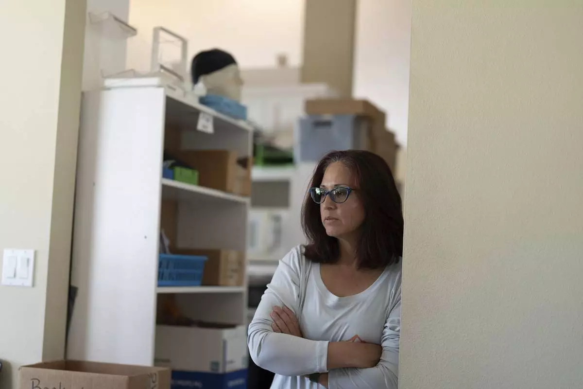 CORRECTS COMPANY NAME: Shannen Knight, owner of A Sight For Sport Eyes, a brick-and-mortar and ecommerce store for sport goggles, looks on while talking about the store on Aug. 20, 2025, in West Linn, Ore. (AP Photo/Jenny Kane)