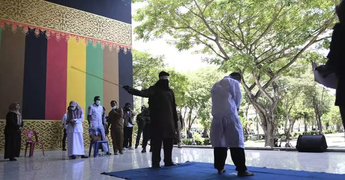 Men charged with hugging and kissing are among group publicly caned by Indonesian Islamic court