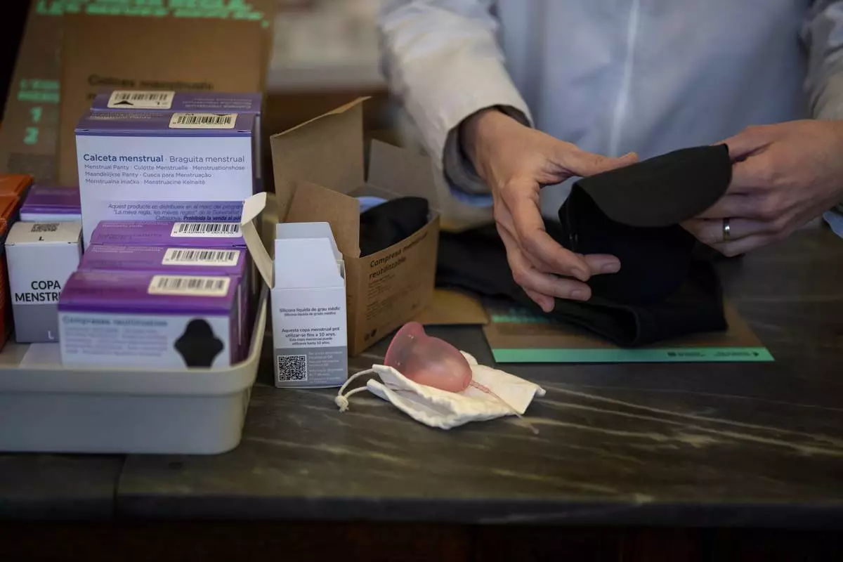 FILE - A pharmacist prepares an underwear for periods next to other items at a pharmacy in Barcelona, Spain, March 5, 2024. (AP Photo/Emilio Morenatti, File)