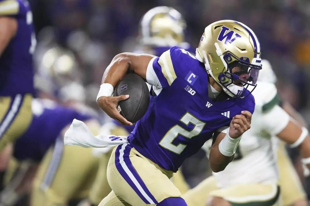 Washington quarterback Demond Williams Jr. runs the ball against Colorado State during the first half of an NCAA college football game Saturday, Aug. 30, 2025, in Seattle. (AP Photo/Lindsey Wasson)