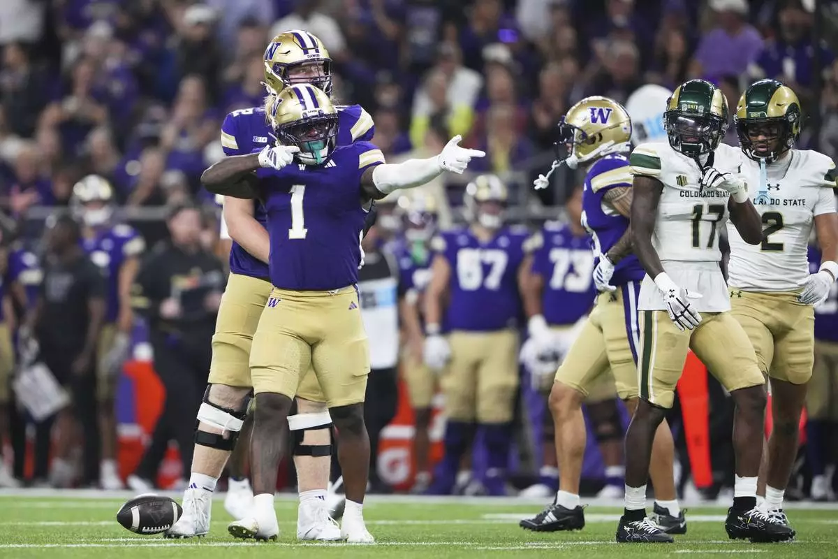 Washington running back Jonah Coleman (1) reacts after a run as Colorado State defensive back CJ Blocker (17) looks on during the first half of an NCAA college football game Saturday, Aug. 30, 2025, in Seattle. (AP Photo/Lindsey Wasson)