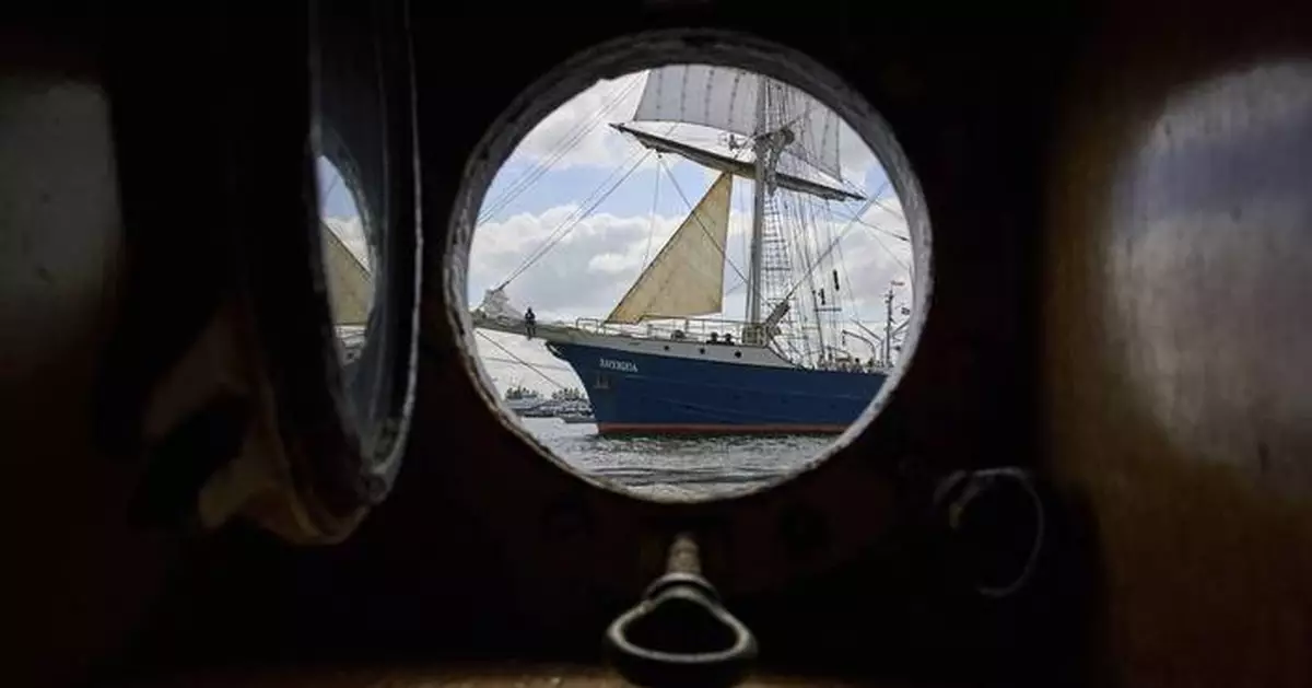 Photos of historic tall ships arriving in Amsterdam for a maritime festival