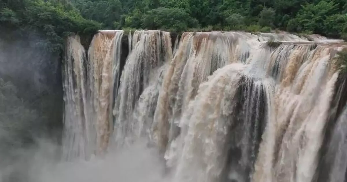 Tourists enjoy fascinating scene of foggy waterfalls in southwest China's Yunnan