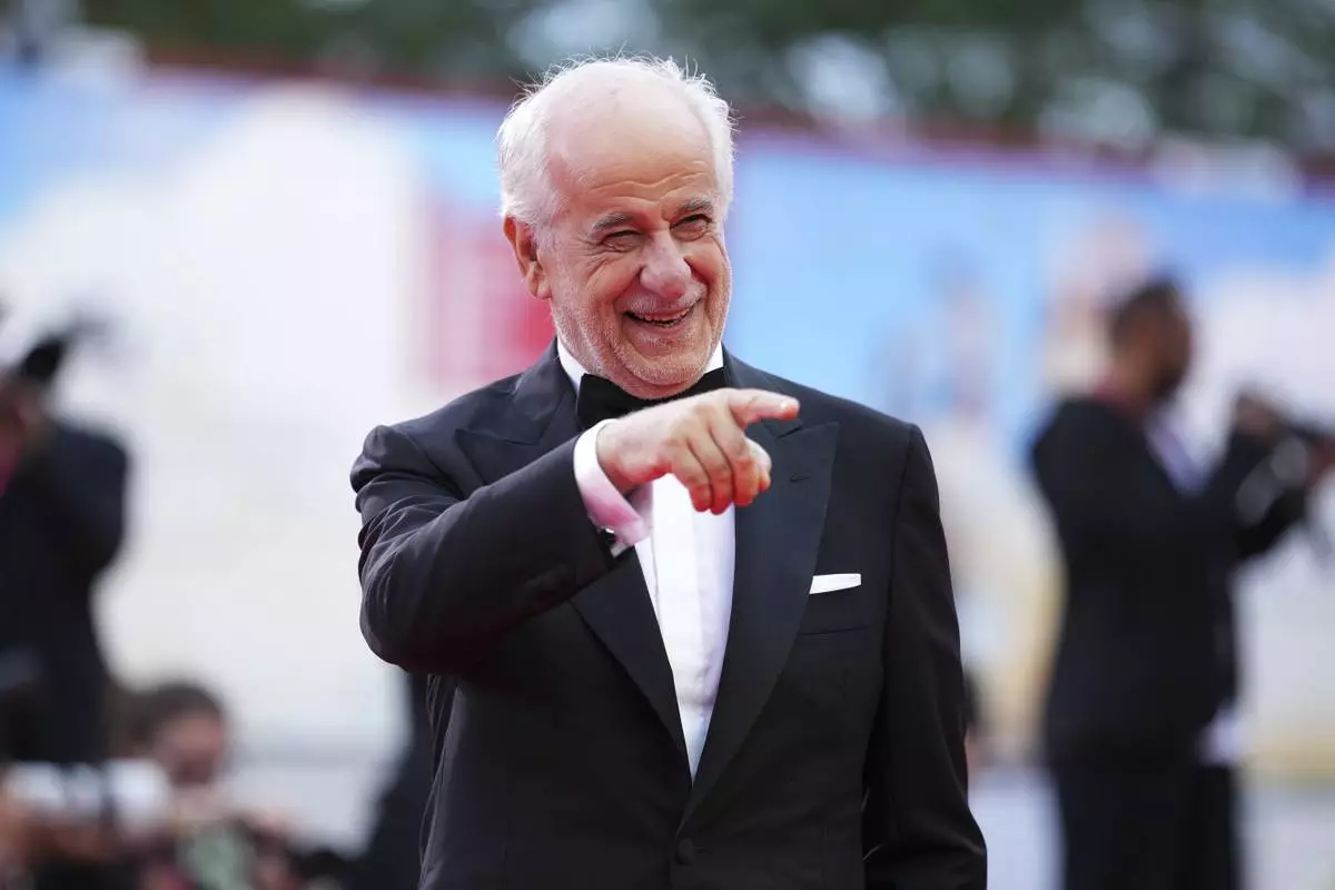 Toni Servillo poses for photographers on the red carpet for the opening ceremony and the premiere of the film 'La Grazia' during the 82nd edition of the Venice Film Festival in Venice, Italy, on Wednesday, Aug. 27, 2025. (Photo by Scott A Garfitt/Invision/AP)