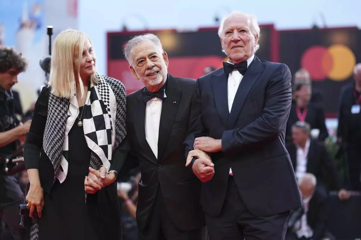 Lena Herzog, from left, Francis Ford Coppola, and Werner Herzog pose for photographers on the red carpet for the opening ceremony and the premiere of the film 'La Grazia' during the 82nd edition of the Venice Film Festival in Venice, Italy, on Wednesday, Aug. 27, 2025. (Photo by Scott A Garfitt/Invision/AP)