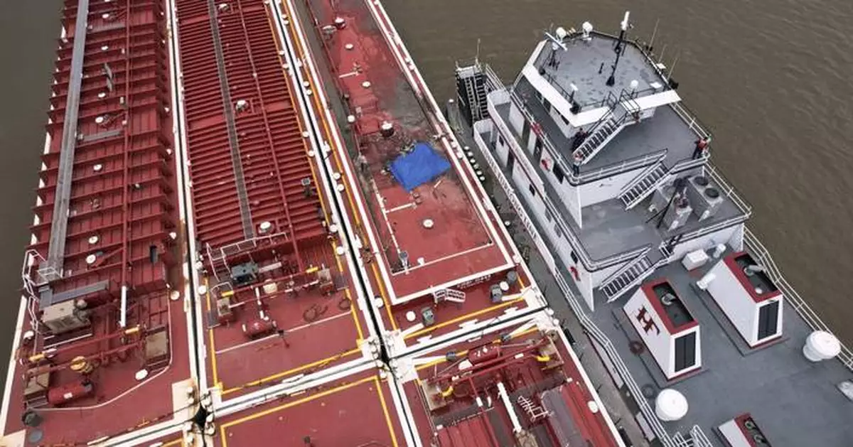 Two die when helicopter strikes powerlines and crashes into a barge on the Mississippi River