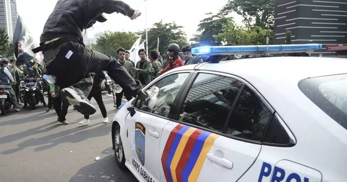 Photos of violent clashes between riot police and protesters in Indonesia