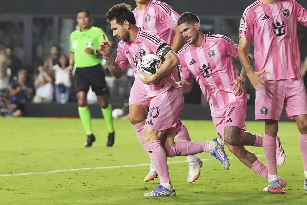 Inter Miami forward Lionel Messi, left, reacts after scoring a goal during the second half of a Leagues Cup semifinal soccer match against Orlando City, Wednesday, Aug. 27, 2025, in Fort Lauderdale, Fla. (AP Photo/Lynne Sladky)