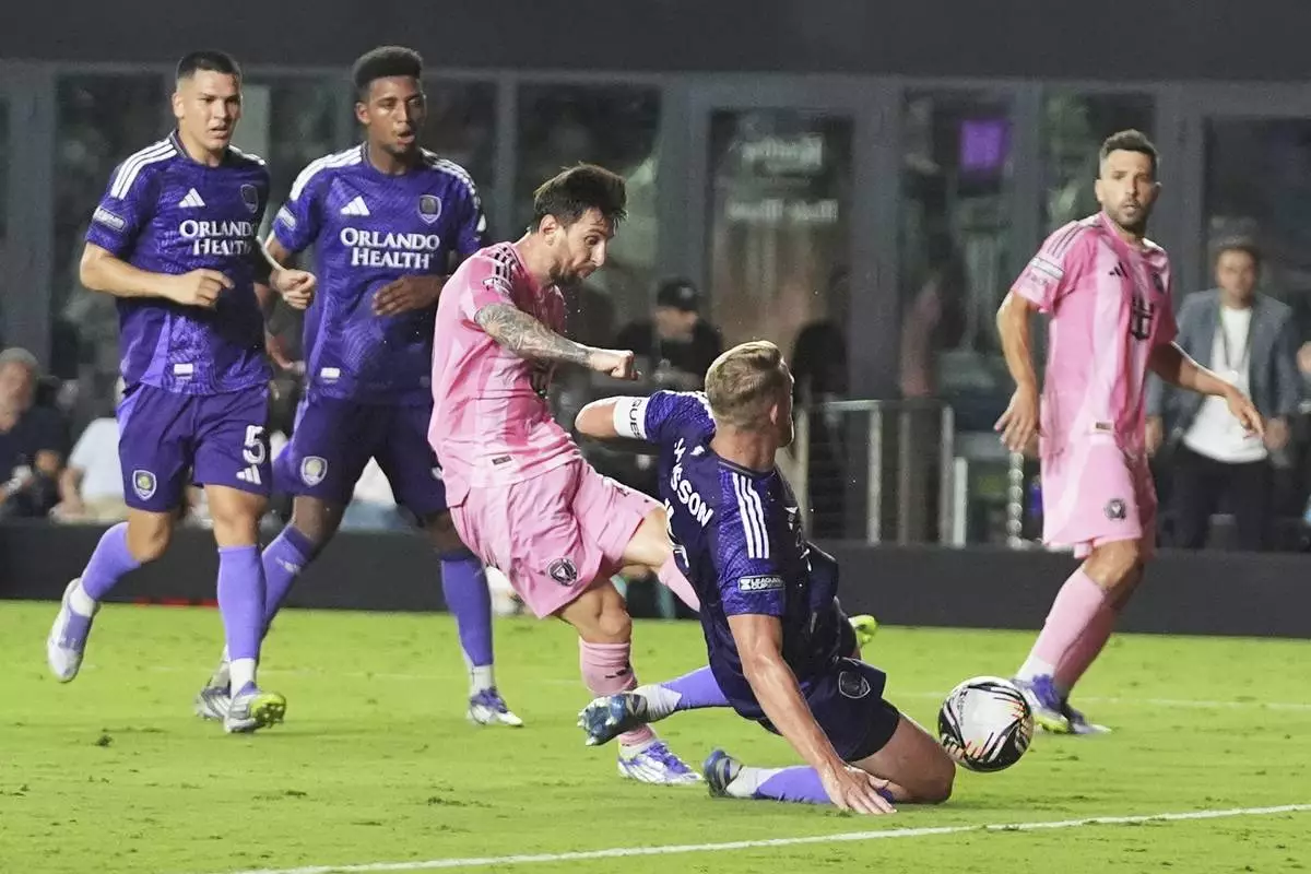 Inter Miami forward Lionel Messi, third from left, scores a goal as Orlando City defender Robin Jansson, second from right, defends during the second half of a Leagues Cup semifinal soccer match, Wednesday, Aug. 27, 2025, in Fort Lauderdale, Fla. (AP Photo/Lynne Sladky)