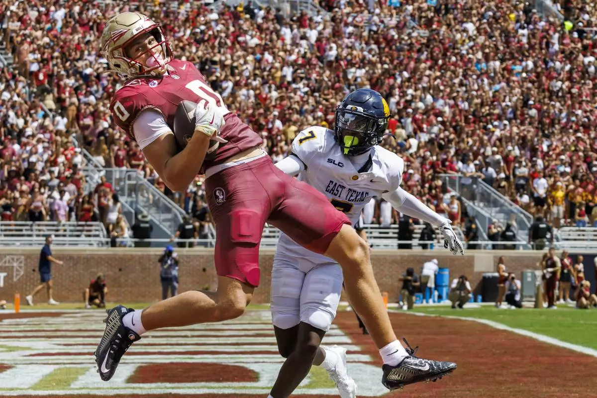 Florida State wide receiver Duce Robinson (0) makes a touchdown catch in front of East Texas A&amp;M defensive back Javon Gillespie (7) during the first half of an NCAA college football game, Saturday, Sept. 6, 2025, in Tallahassee, Fla. (AP Photo/Colin Hackley)