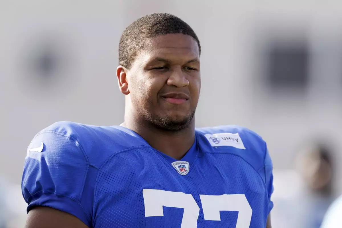 FILE - Los Angeles Rams offensive tackle Alaric Jackson (77) walks on the field during an NFL training camp, July 29, 2025, in Los Angeles. (AP Photo/Eric Thayer, File)