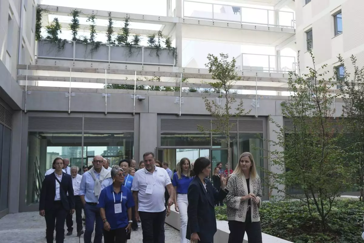 Executive Board and the IOC President Kirsty Coventry, right, visit the Olympic and Paralympic Village in Milan, Italy, Thursday, Sept. 18, 2025. (AP Photo/Antonio Calanni)
