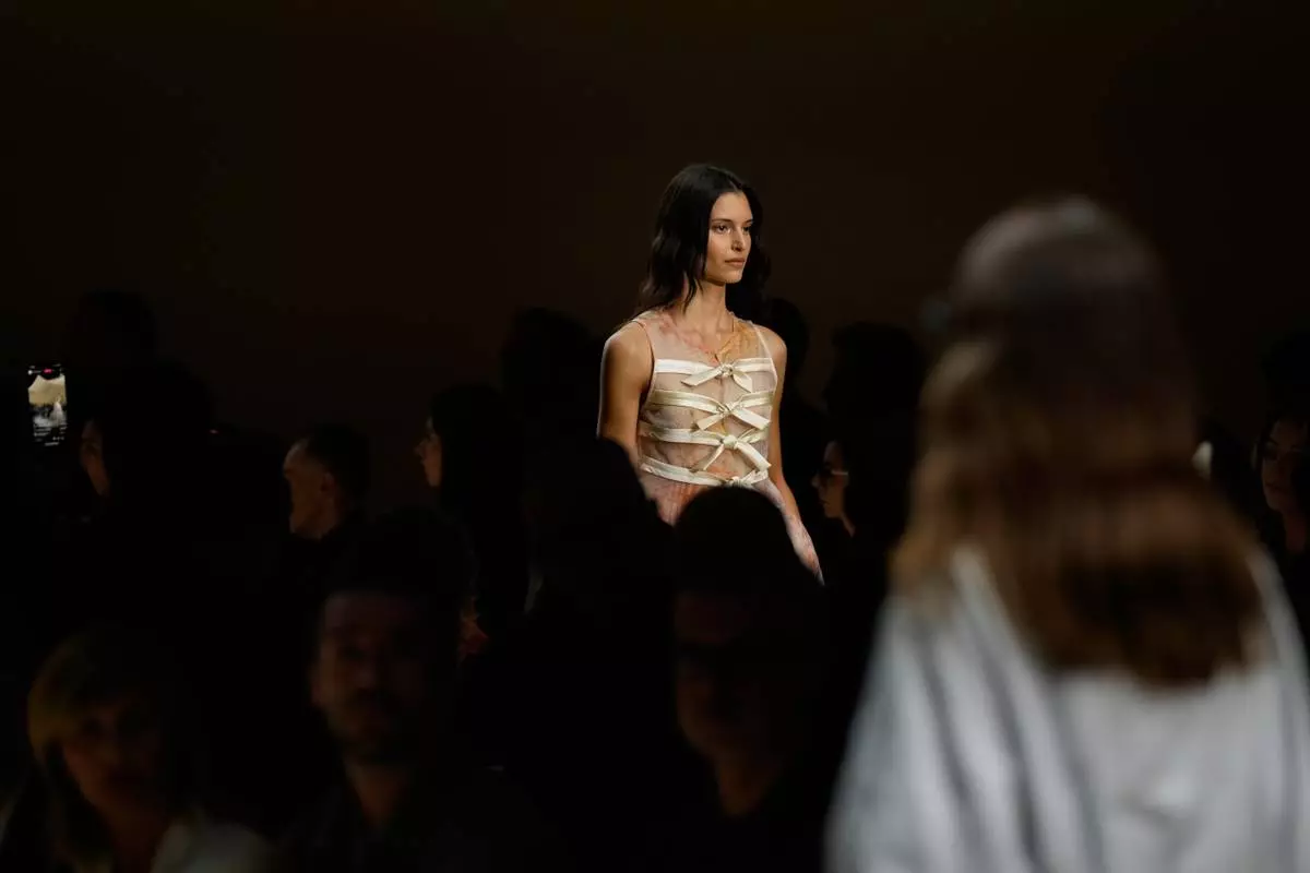 Models wear creations part of the Emporio Armani women's Spring-Summer 2026 collection, presented in Milan, Italy, Thursday, Sept. 25, 2025. (AP Photo/Luca Bruno)