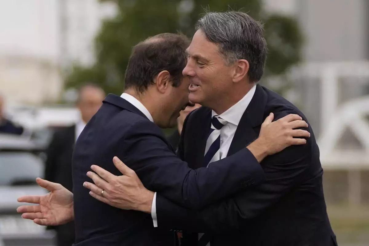 French Defense Minister Sebastien Lecornu, left, welcomes Deputy Prime Minister of Australia and Minister for Defense Richard Marles during a ceremony on Sept. 1, 2022, in Brest, Brittany, France. (AP Photo/Francois Mori, File)
