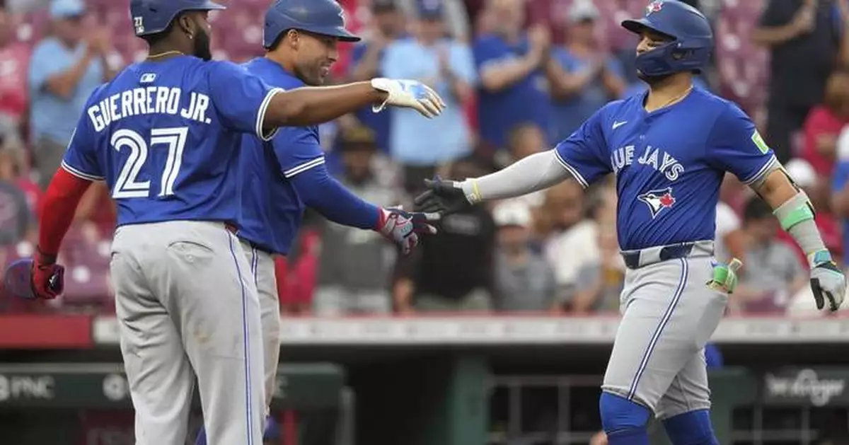 Springer goes deep twice as Blue Jays hold off Reds, 12-9