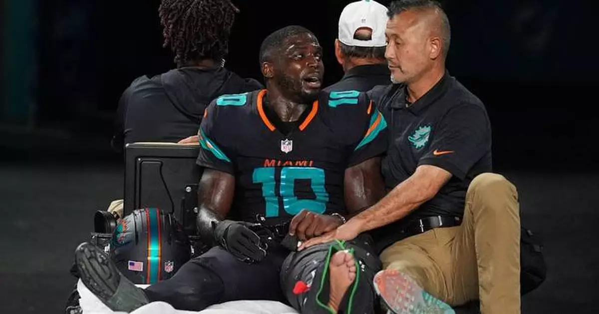 Dolphins' Tyreek Hill carted off field and taken to hospital with dislocated left knee