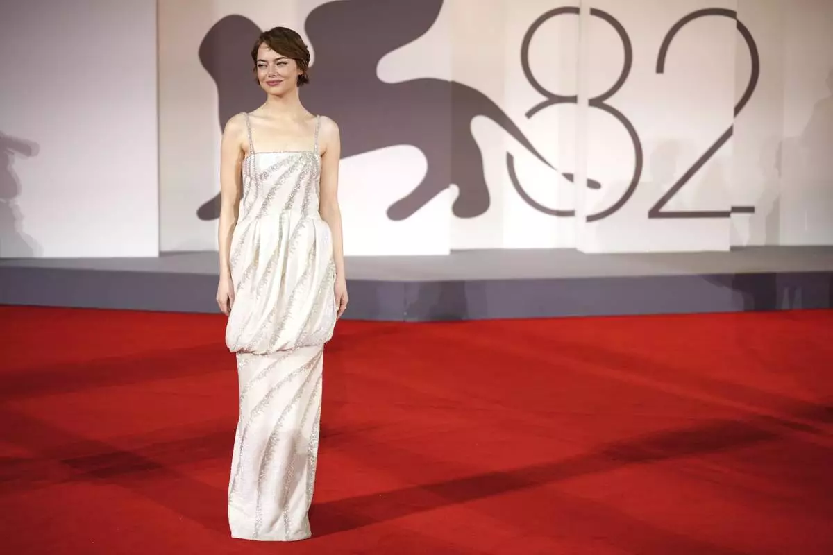 Emma Stone poses for photographers on the red carpet for the film 'Bugonia' during the 82nd edition of the Venice Film Festival in Venice, Italy, on Thursday, Aug. 28, 2025. (Photo by Alessandra Tarantino/Invision/AP)