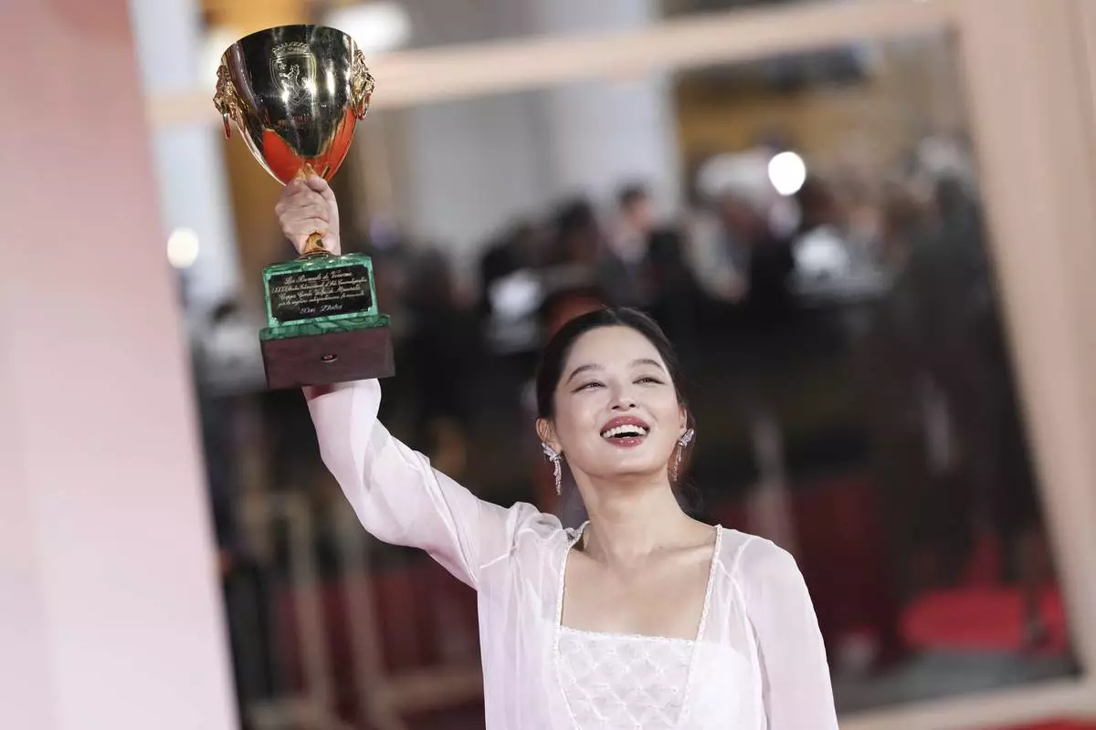 Xin Zhilei, winner of the Coppa Volpi award for best actress for 'The Sun Rises on Us All', poses for photographers at the awards photo call during the 82nd edition of the Venice Film Festival in Venice, Italy, on Saturday, Sept. 6, 2025. (Photo by Scott A Garfitt/Invision/AP)