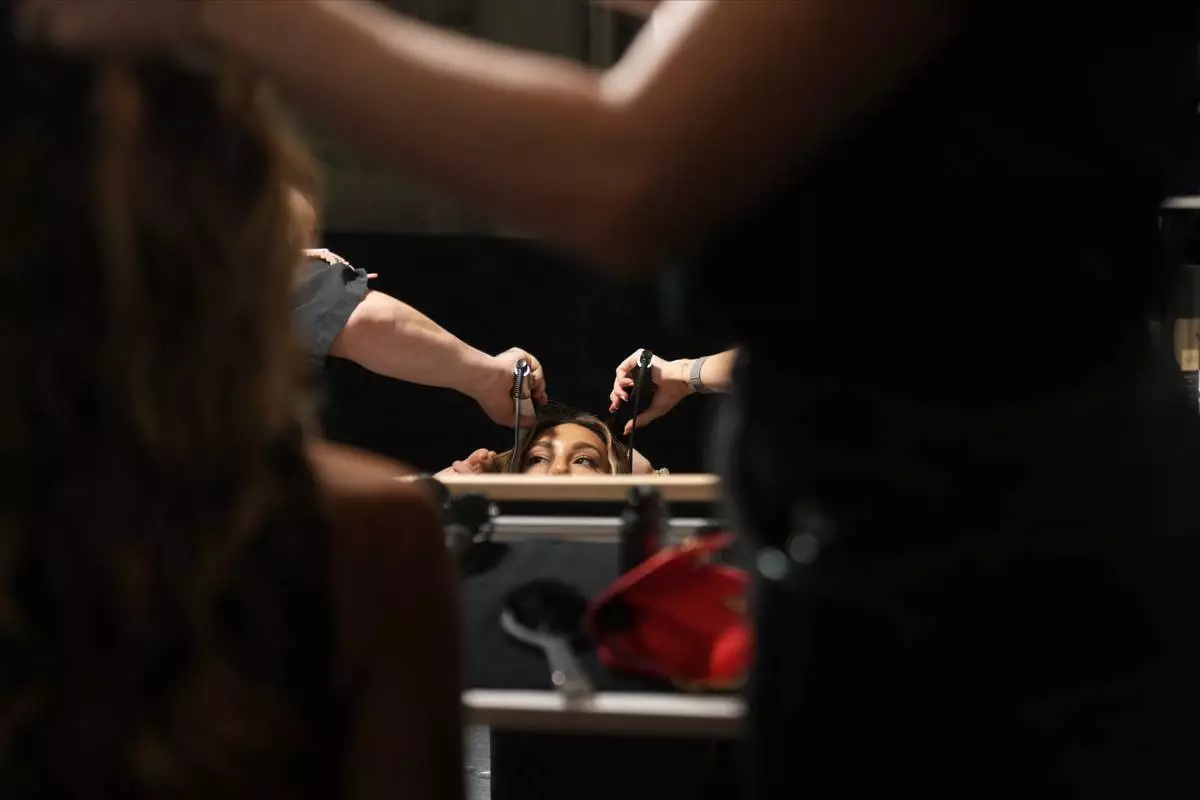 A model prepares in the backstage of the Roberto Cavalli 2026 Spring/Summer fashion show in Milan, Italy, Thursday, Sept. 25, 2025. (AP Photo/Antonio Calanni)