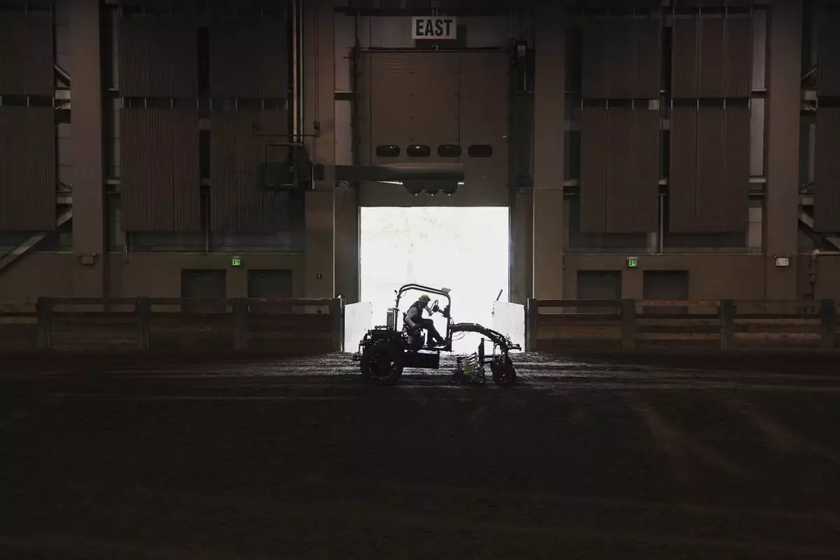 Ben Phillips test drives an electric tractor Tuesday, Aug. 19, 2025, during a demonstration in East Lansing, Mich. (AP Photo/Joshua A. Bickel)