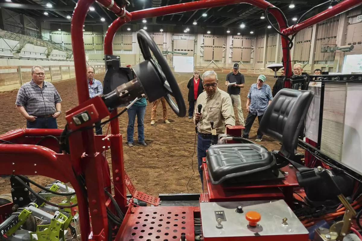 Ajit Srivastava, an engineering professor at Michigan State University, talks about an electric tractor in development Tuesday, Aug. 19, 2025, during a demonstration in East Lansing, Mich. (AP Photo/Joshua A. Bickel)