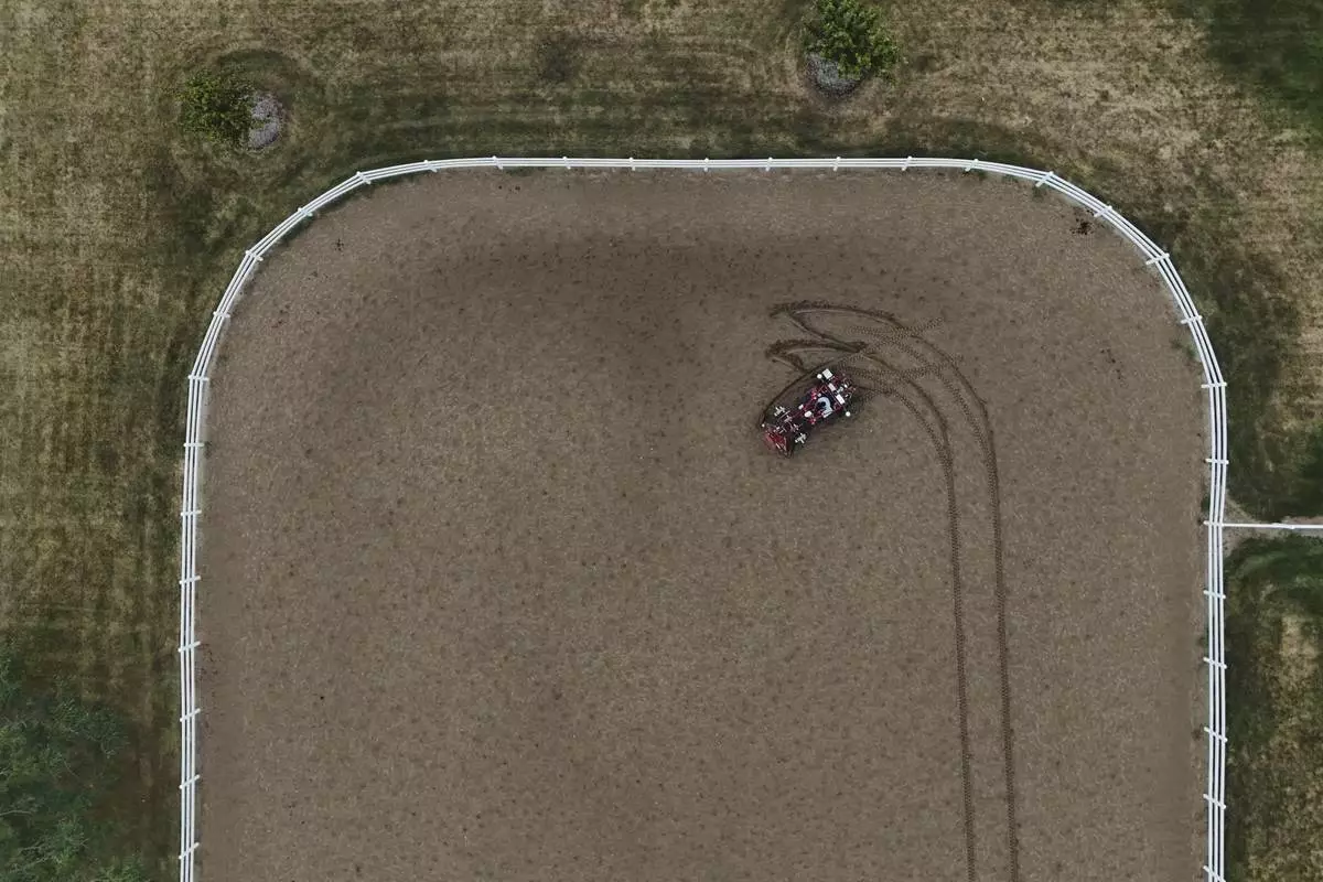MK Bashar drives an electric tractor Tuesday, Aug. 19, 2025, during a demonstration in East Lansing, Mich. (AP Photo/Joshua A. Bickel)