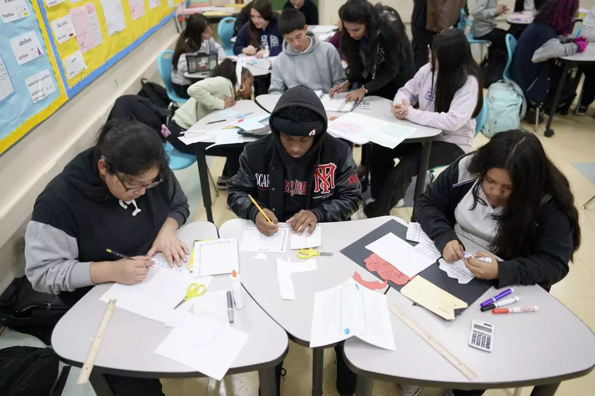 FILE - Students work in a classroom at Benjamin O. Davis Middle School in Compton, Calif., Thursday, Feb. 6, 2025. (AP Photo/Eric Thayer, file)