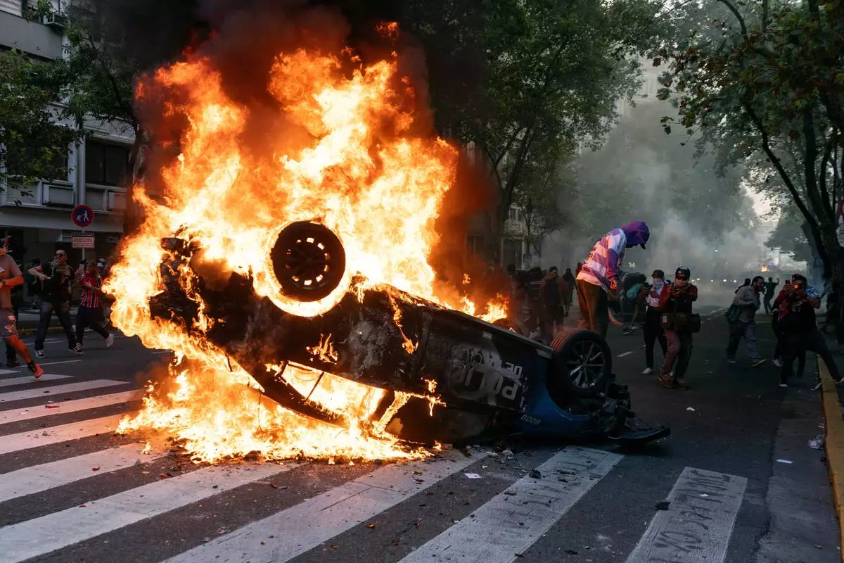 FILE PHOTO GALLERY - A police car goes up in flames, set on fire during a protest led by soccer fans in support of retirees demanding higher pensions and opposing austerity measures implemented by Javier Milei's government, in Buenos Aires, Argentina, March 12, 2025. (AP Photo/Rodrigo Abd, File)