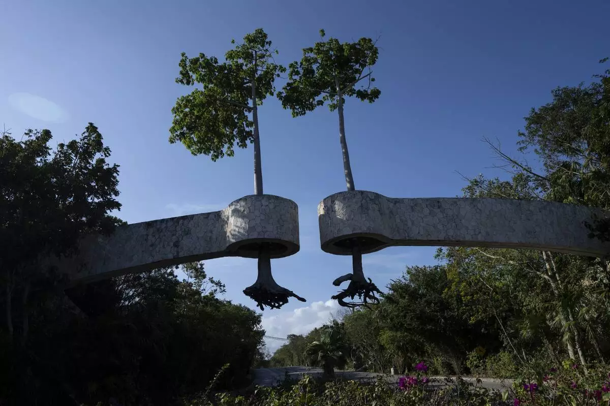 FILE PHOTO GALLERY - Uprooted trees serving as decor are suspended over the entrance of a tourist complex in Playa del Carmen, Mexico, March 7, 2024. Once a Mayan settlement, the city is among many in the Yucatan Peninsula that in recent decades have been converted into a party hub for vacationing foreigners. (AP Photo/Rodrigo Abd)