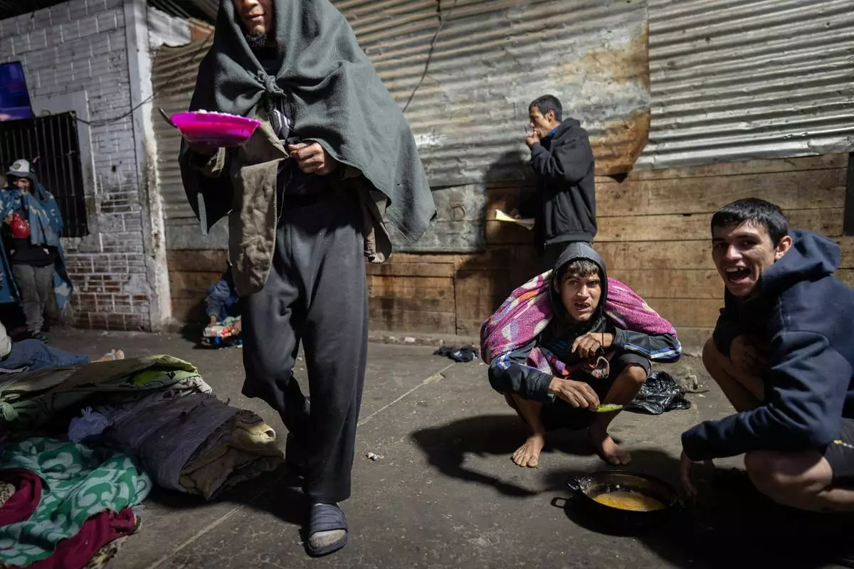 FILE PHOTO GALLERY - Prisoners eat a jail-provided soup known as "vori vori" at the Tacumbu prison in Asuncion, Paraguay, July 8, 2024. The soup, made of chicken or beef, vegetables, and corn balls stuffed with cheese, is considered the food of the poorest inmates. (AP Photo/Rodrigo Abd)