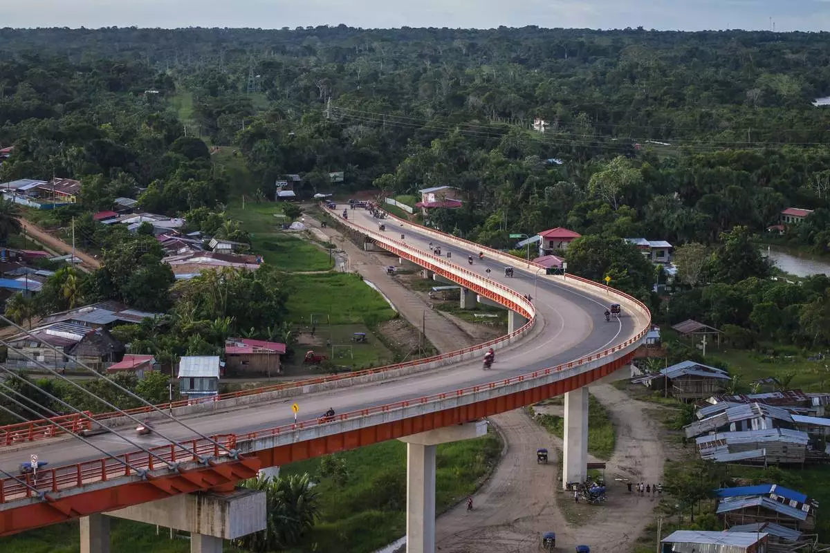 FILE PHOTO GALLERY - Residents drive on a bridge, part of a federal highway project that extends over the Nanay River, in Iquitos, Peru, May 26, 2024. Construction work is at a standstill as the government conducts a study of the area, but the Ministry of Transportation has already built what is the country's largest bridge, which extends 2.3 kilometers (1.4 miles) over the Nanay, a tributary of the Amazon River. (AP Photo/Rodrigo Abd)