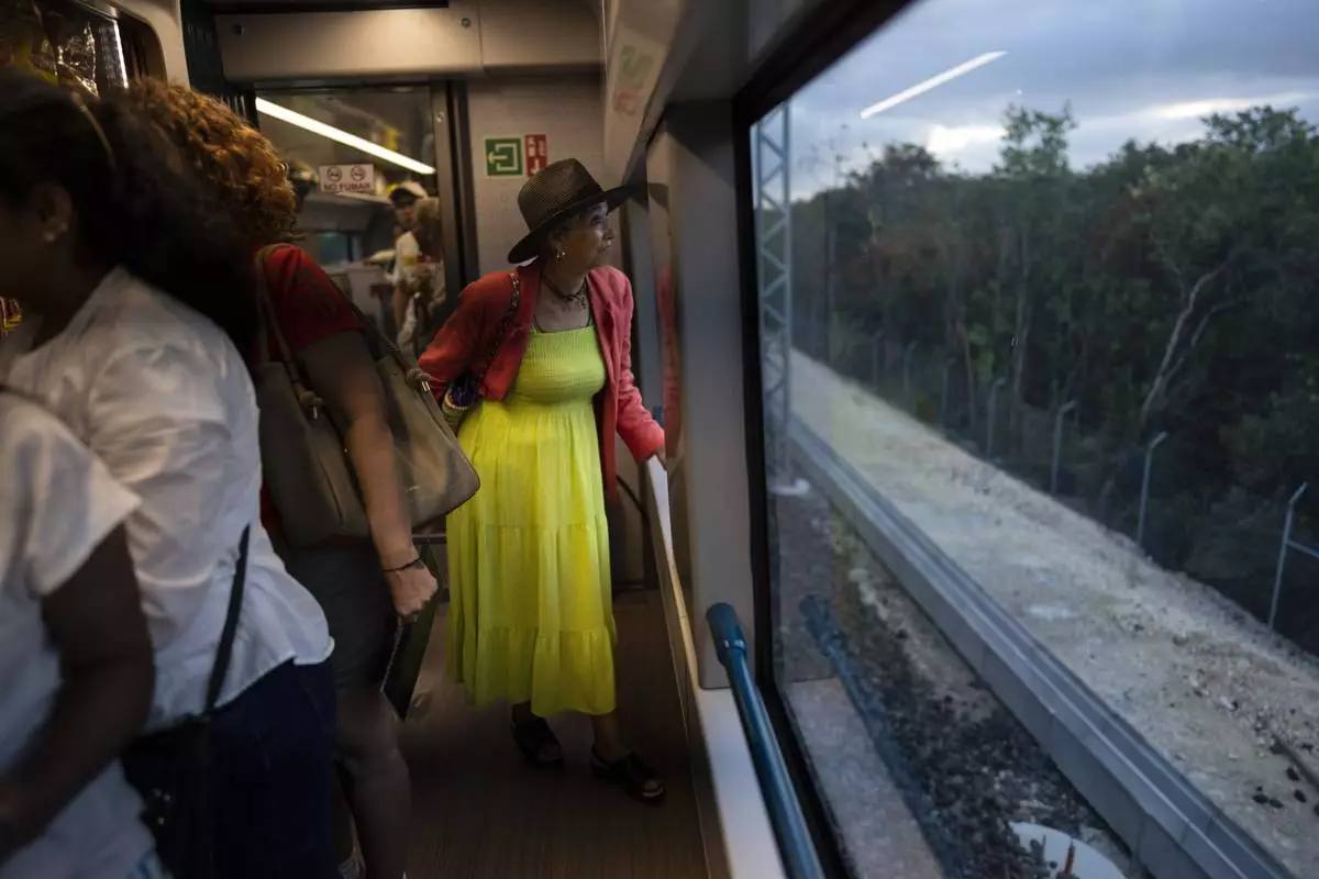 FILE PHOTO GALLERY - A passenger looks at the passing jungle landscape while traveling on the Maya Train from Cancun to Valladolid, Mexico, March 6, 2024. (AP Photo/Rodrigo Abd)