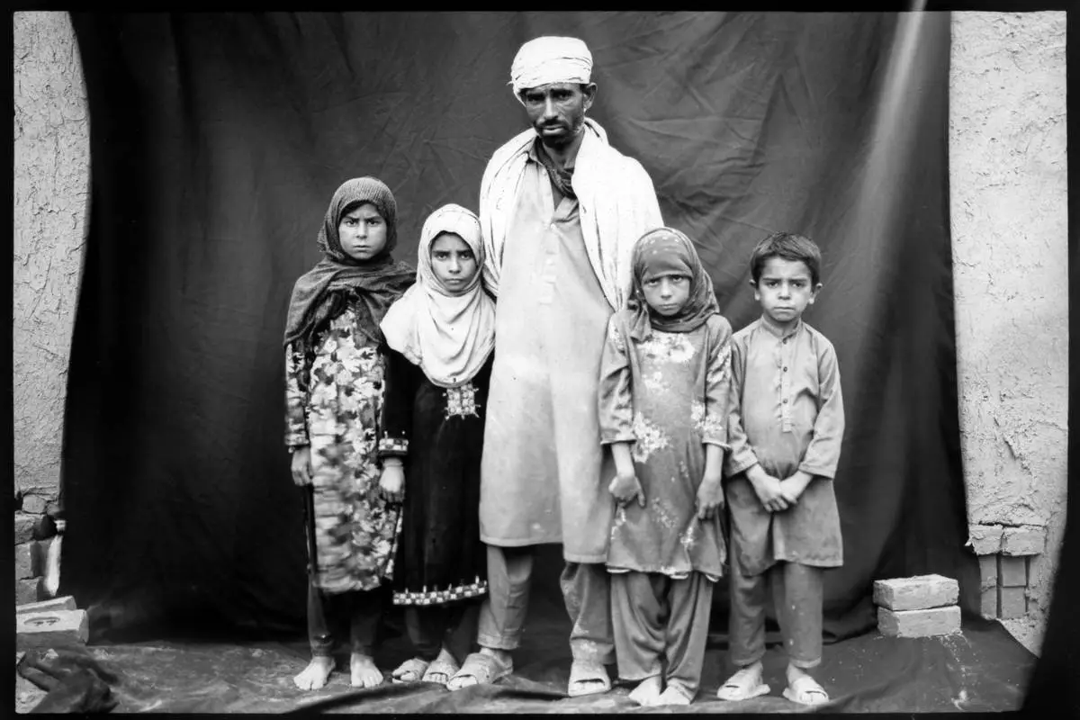 FILE PHOTO GALLERY - Seasonal brick worker Ibrahim poses for a portrait with his children, from left to right, Arzo,10; Okhkulah, 9; Rana, 8; and Abobaker, 7, while taking a break from working in a brick factory on the outskirts of Kabul, Afghanistan, May 30, 2023. (AP Photo/Rodrigo Abd, File)