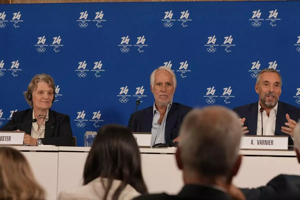From left, Kristin Kloster, President of the IOC Coordination Commission, Giovanni Malago' and Andrea Varnier attend a news conference of the Organising Committee of the Olympic Winter Games Milano Cortina 2026, following the meeting of the IOC Coordination Commission, in Milan, Italy, Wednesday, Sept. 17, 2025. (AP Photo/Luca Bruno)