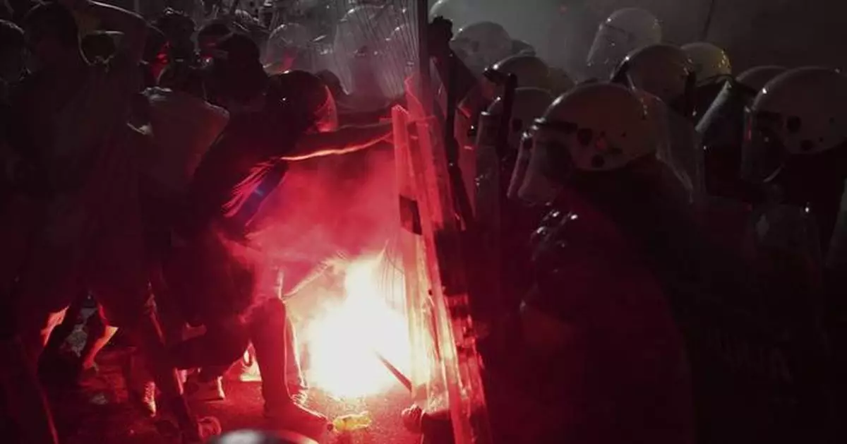 Tear gas fired at thousands of protesters in Serbia demanding free elections and justice