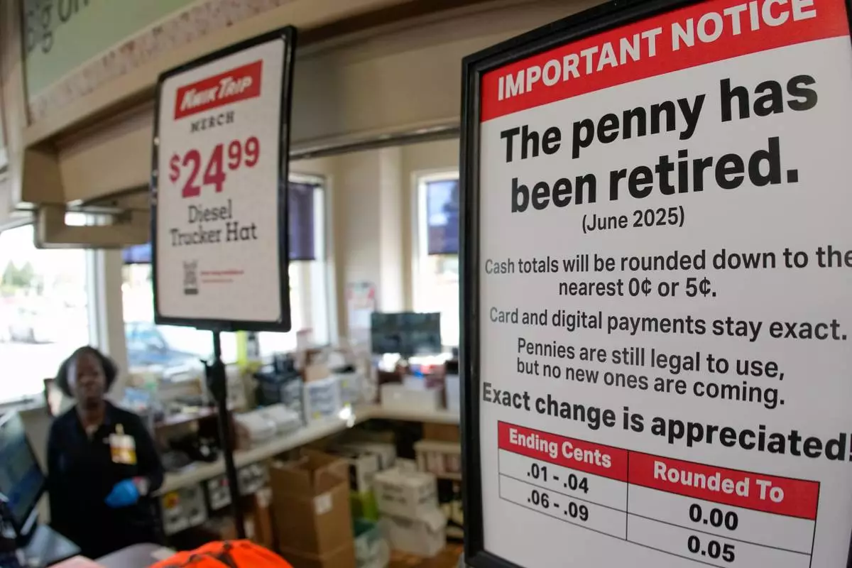 A sign in a Kwik Trip store shows the store will no longer be using pennies to give change, on Oct. 23, 2025, in Yorkville, Wis. (AP Photo/Morry Gash)