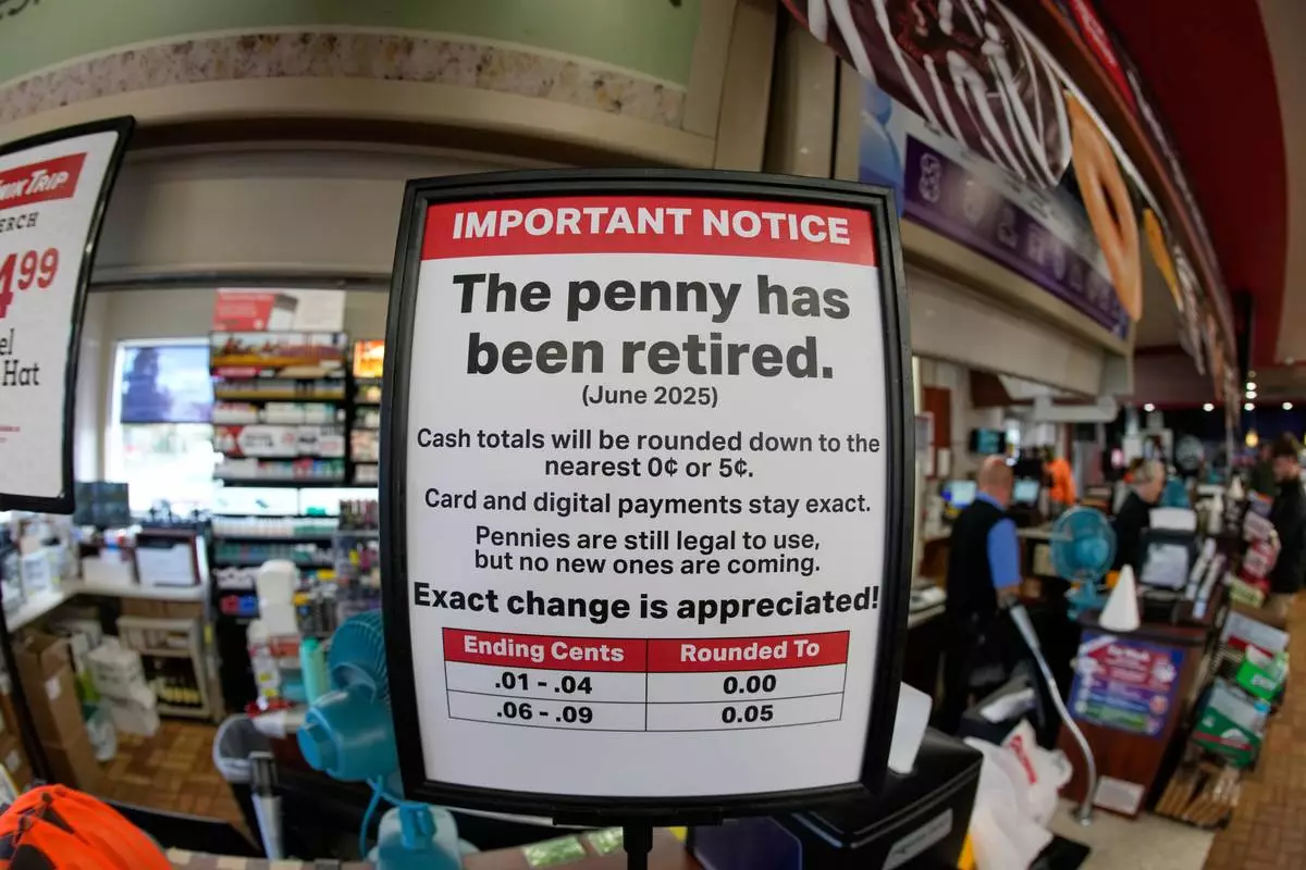 A sign in a Kwik Trip store shows the store will no longer be using pennies to give change, on Oct. 23, 2025, in Yorkville, Wis. (AP Photo/Morry Gash)