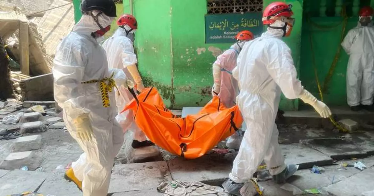 Death toll from Indonesian school collapse rises to 14 as crews pull more bodies from rubble