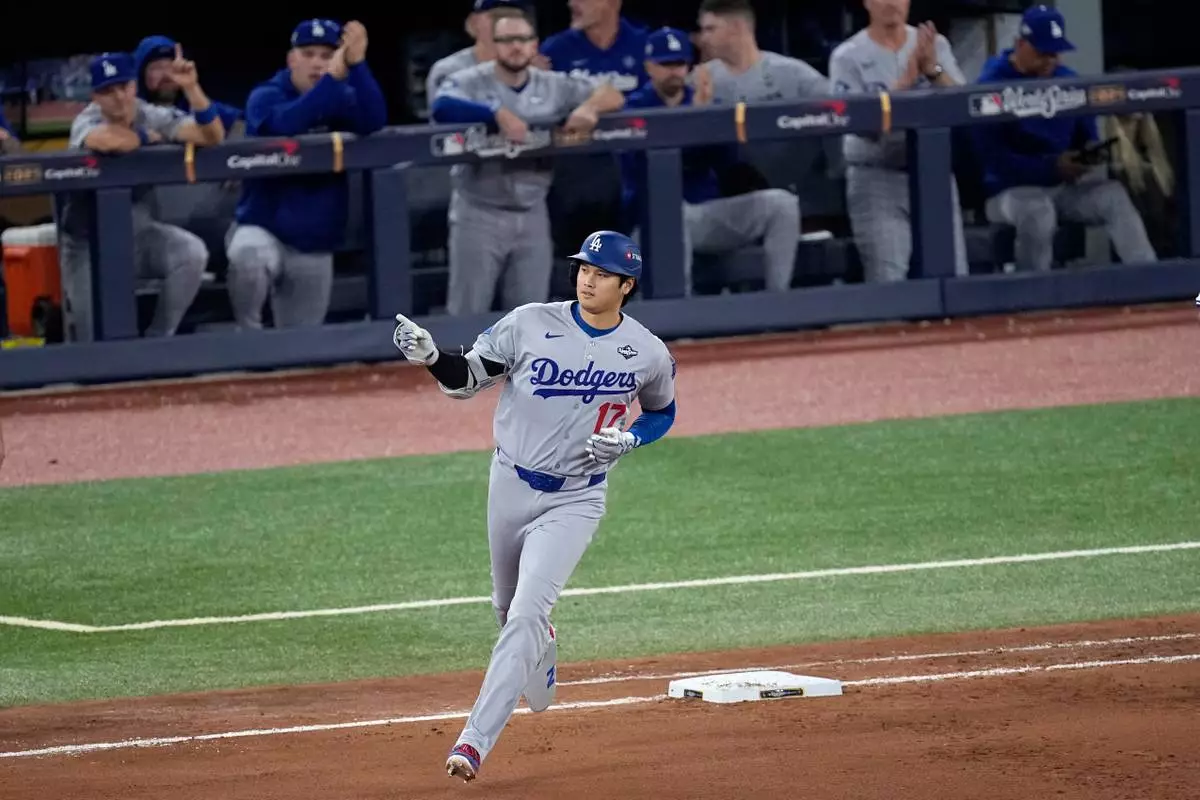 Los Angeles Dodgers' Shohei Ohtani rounds the bases after hitting a two run home run against the Toronto Blue Jays during the seventh inning in Game 1 of baseball's World Series, Friday, Oct. 24, 2025, in Toronto. (AP Photo/David J. Phillip)