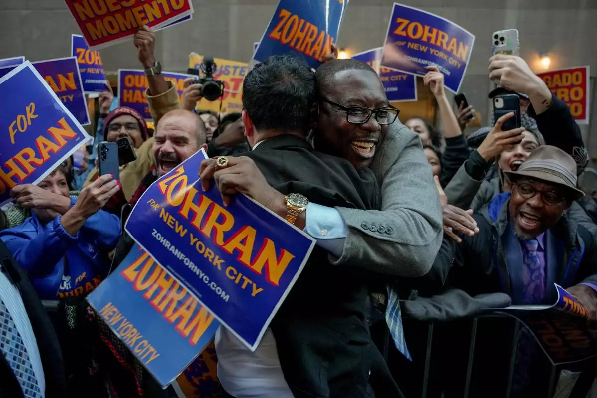 Democratic candidate Zohran Mamdani, left, greets supporters upon arriving to participate in a mayoral debate, Thursday, Oct. 16, 2025, in New York. (AP Photo/Angelina Katsanis)