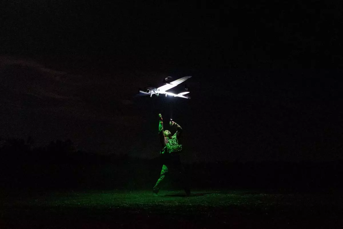 A Ukrainian serviceman with the Safari Unit of the Liut Brigade launches a reconnaissance drone at the frontline in the Donetsk region, Ukraine, on Sept. 6, 2025. (AP Photo/Vasilisa Stepanenko)