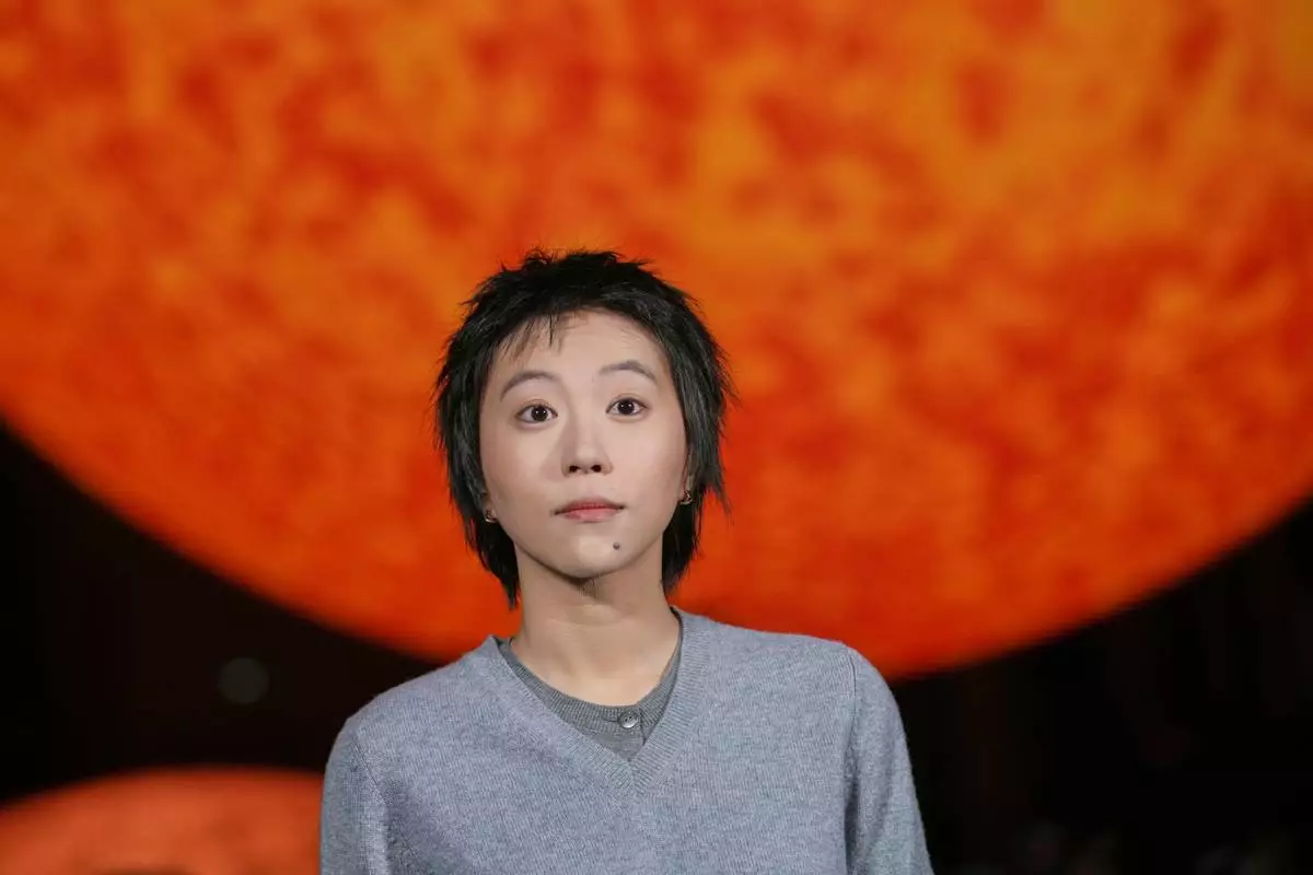 Leah Dou poses for photographers upon arrival at the Chanel Spring/Summer 2026 collection presented in Paris, Monday, Oct. 6, 2025. (AP Photo/Christophe Ena)