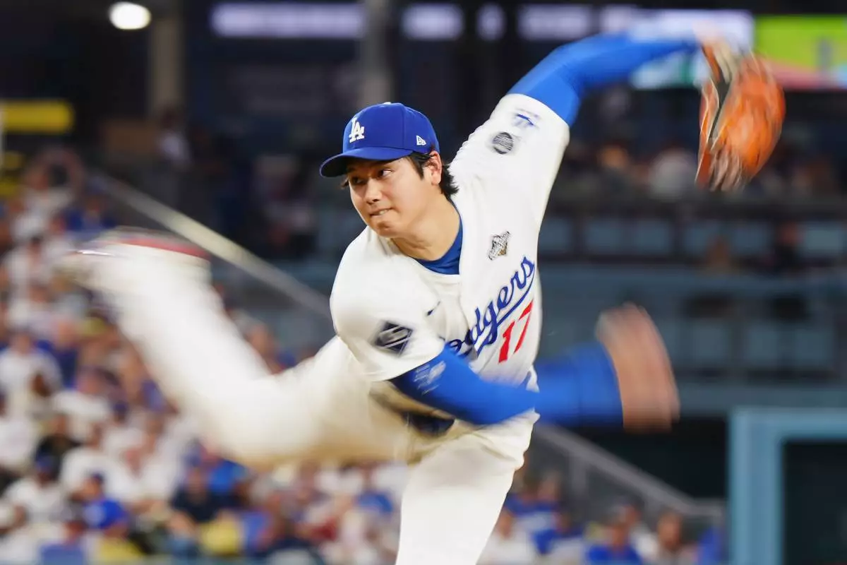 Los Angeles Dodgers pitcher Shohei Ohtani (17) delivers a pitch against the Toronto Blue Jays during fourth inning Game 4 World Series playoff MLB baseball action in Los Angeles on Tuesday, Oct. 28, 2025. (Frank Gunn/The Canadian Press via AP)