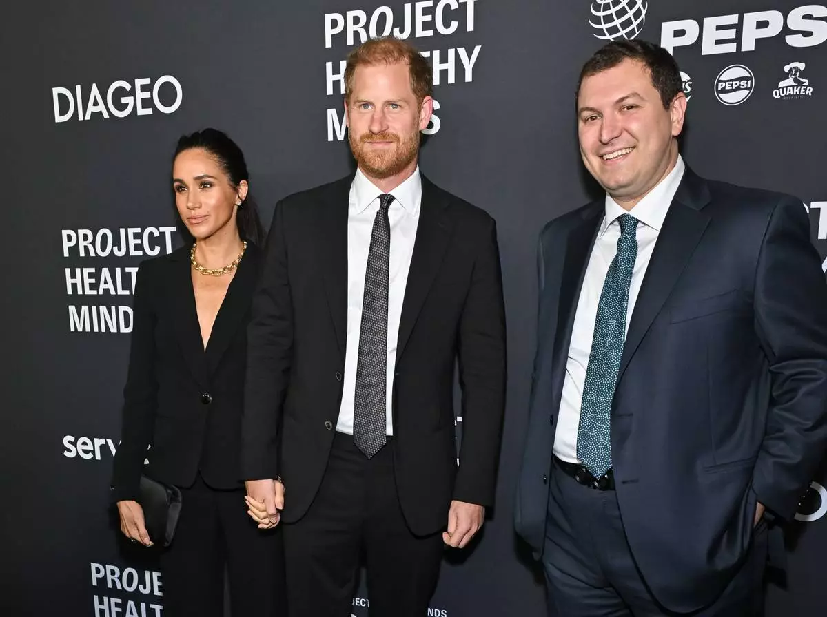 Meghan Markle, left, and Prince Harry, The Duke and Duchess of Sussex, center, pose with Project Healthy Minds founder and CEO Phillip Schermer at the third annual World Mental Health Day Gala, hosted by Project Healthy Minds, at Spring Studios on Thursday, Oct. 9, 2025, in New York. (Photo by Evan Agostini/Invision/AP)