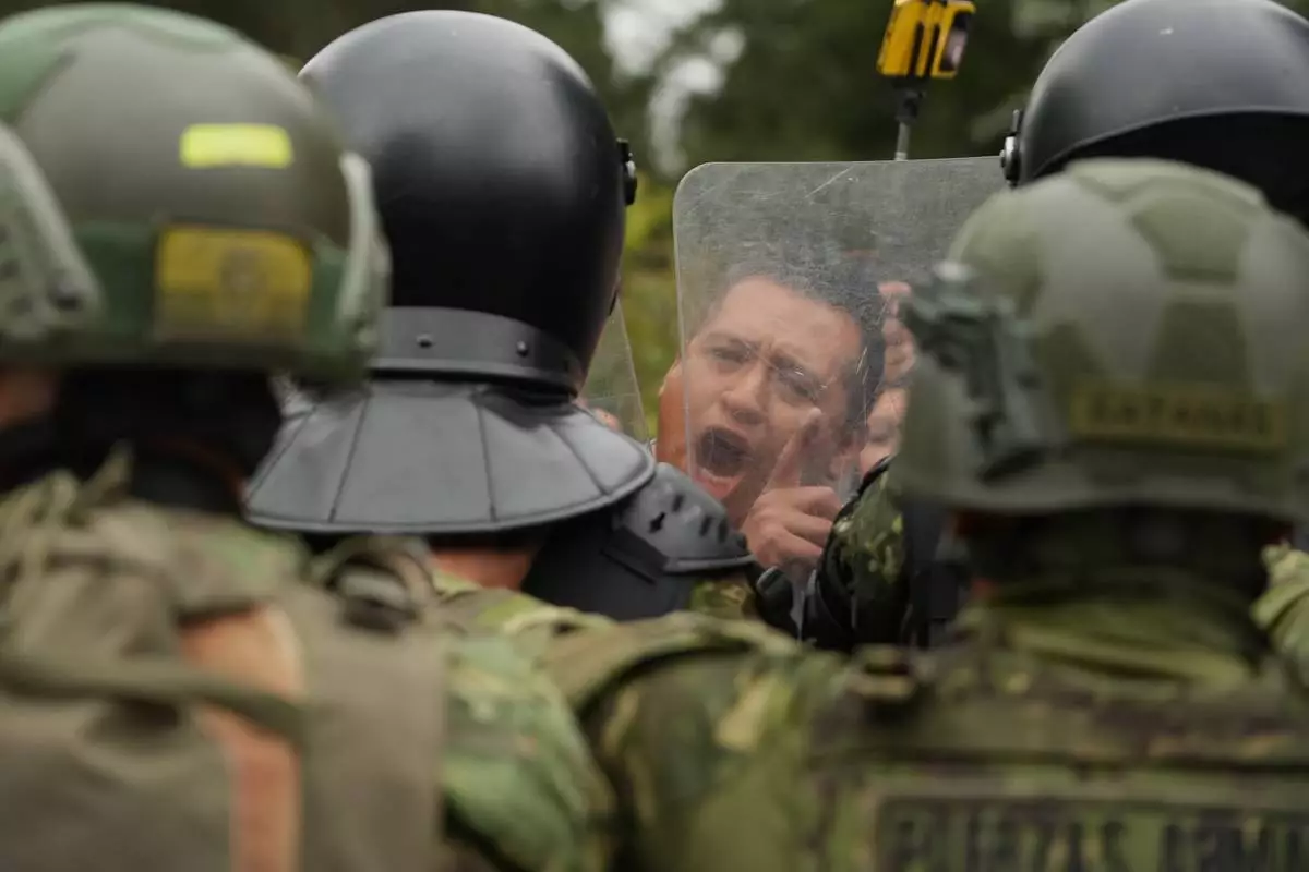 A man faces off with soldiers during an anti-government protest in Quito, Ecuador, Oct. 15, 2025. (AP Photo/Dolores Ochoa)