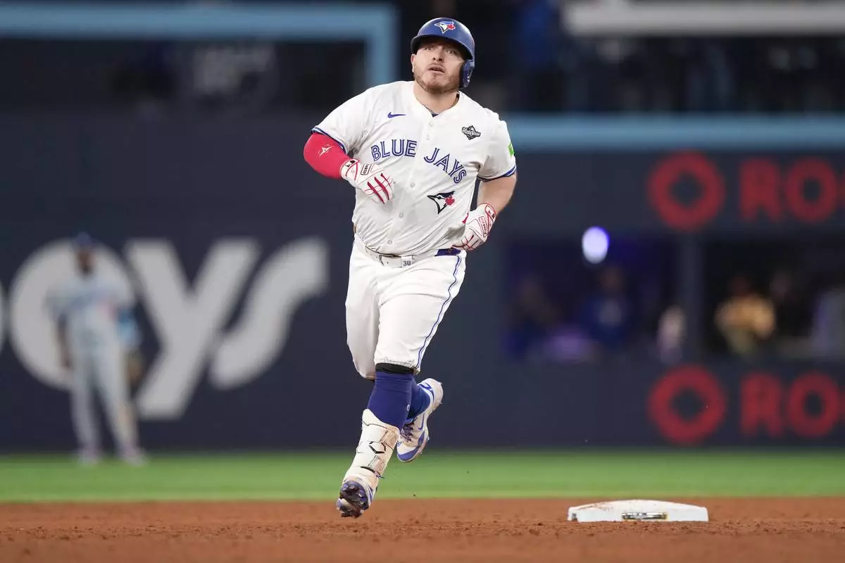 Toronto Blue Jays' Alejandro Kirk rounds the bases after hitting a two-run home run against the Los Angeles Dodgers during the sixth inning in Game 1 of baseball's World Series, Friday, Oct. 24, 2025, in Toronto. (Nathan Denette/The Canadian Press via AP)