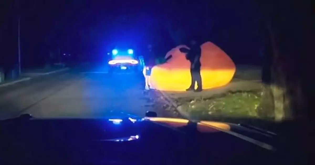 After a police pursuit of a huge inflatable pumpkin, body cam video shows officer struggling with it