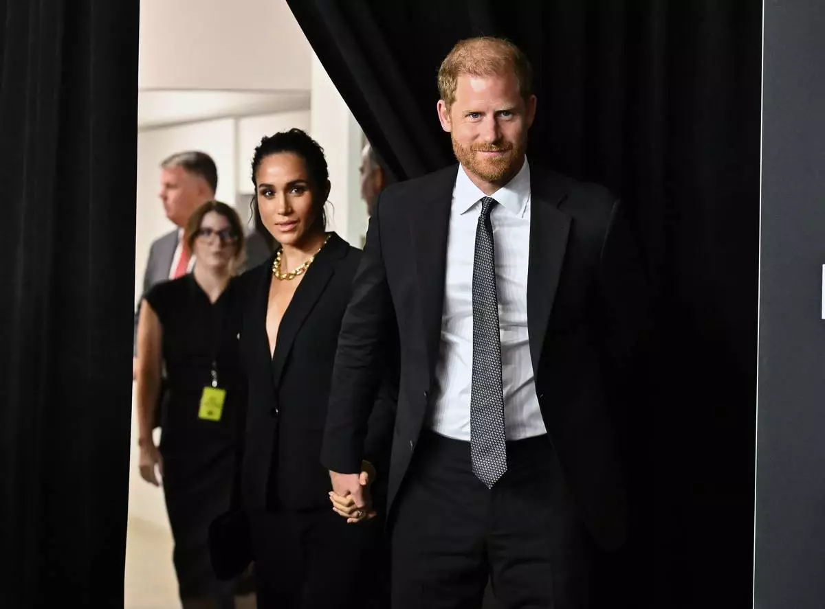 Meghan Markle, left, and Prince Harry, The Duke and Duchess of Sussex, attend the third annual World Mental Health Day Gala, hosted by Project Healthy Minds, at Spring Studios on Thursday, Oct. 9, 2025, in New York. (Photo by Evan Agostini/Invision/AP)