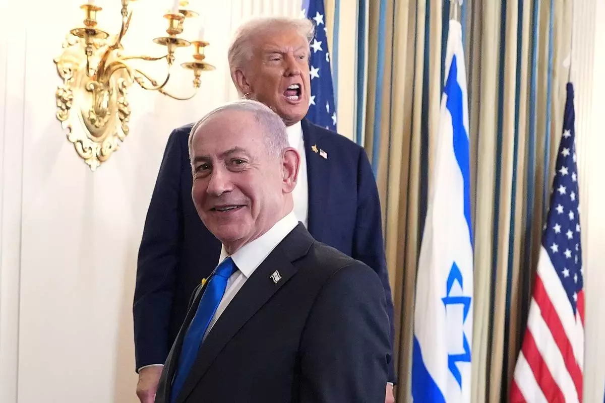 President Donald Trump speaks upon departing a news conference with Israeli Prime Minister Benjamin Netanyahu, in foreground, in the State Dining Room of the White House, Monday, Sept. 29, 2025, in Washington. (AP Photo/Evan Vucci)